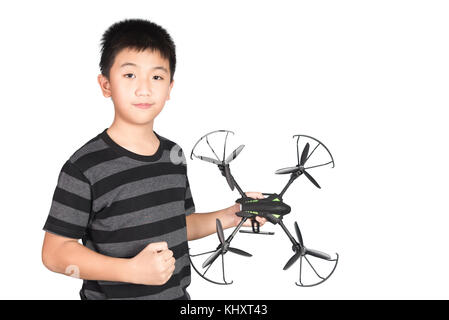 Successful happy and attractive Asian boy holding hexacopter drone and punching the air with his fist, isolated on white background. Stock Photo