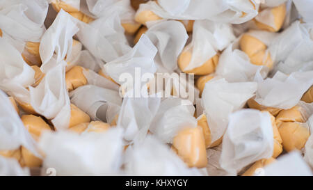 Stack of salt water taffy, delicious and chewy, wrapped in waxed paper in a candy store in San Francisco, California Stock Photo