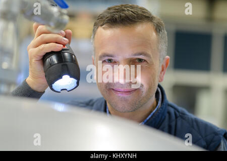 man with a flashlight in hand Stock Photo