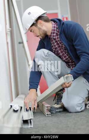 Workman holding pvc frames Stock Photo