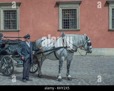 Warsaw, Poland - June 02, 2017: Cabman takes a break when waiting for the next passengers in Old Town Market Place, Warsaw, Poland Stock Photo