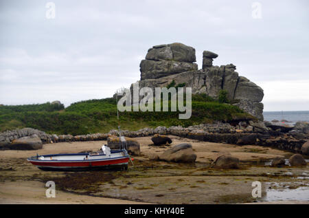 The Loaded Camel Rock Formation and Boat in Porth Hellick Bay on the Island of St Marys in the Isles of Scilly, UK. Stock Photo