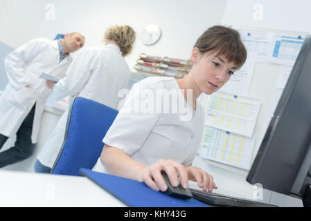 female doctor using a computer to write a repport Stock Photo