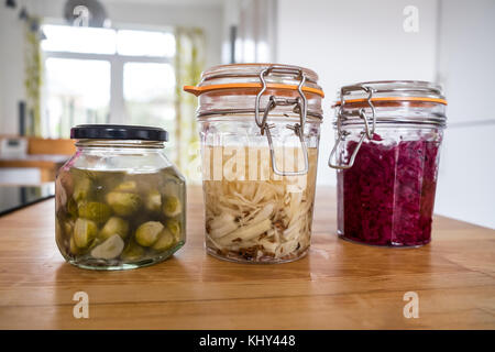 Fermented sauerkraut and sprout kraut in sealed jars, probiotic food Stock Photo