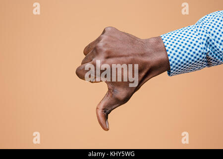 Thumb down hand sign on brown, seal of disapproval Stock Photo