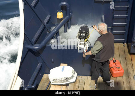 Engineer working on skiff motor Stock Photo