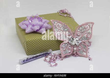 Gift box and lilac decorative butterfly on a light background Stock Photo