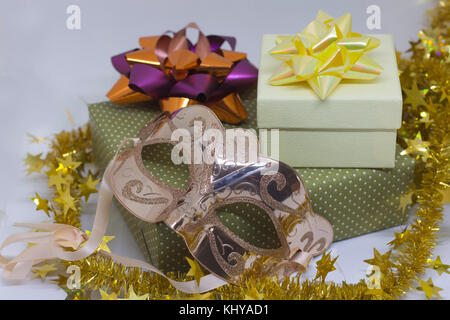 Two gift boxes and carnival mask on white background Stock Photo