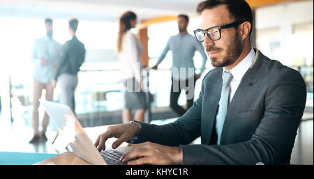 Professional businessman working on laptop in office Stock Photo