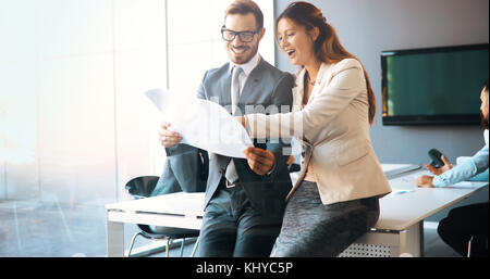 Business colleagues collaborating and discussing project plans Stock Photo