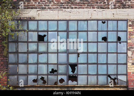 Broken window on vacated industrial hall Stock Photo