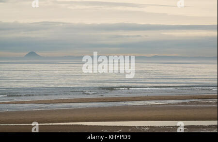 Portobello, Edinburgh, Scotland, United Kingdom, 21st November 2017.  Glimpses of faint pastel colours in the sky on the horizon from Portobello beach looking towards Berwick Law on a misty day Stock Photo