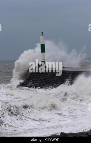 Aberystwyth Wales UK, Wednesday 22 November 2017 UK Weather: High tides and strong winds, gusting up to 50 mph, combine to bring waves crashing into the sea defences and promenade in the early morning in Aberystwyth, on the Cardigan Bay coast of west wales. The Met Office has issued a yellow warning for wind for much of England and Wales for the whole of the day, with delays to road, rail, air and ferry transport likely whilst outbreaks of rain, occasionally heavy, will add to the difficult travel conditions photo Credit: Keith Morris/Alamy Live News Stock Photo