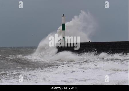 Aberystwyth Wales UK, Wednesday 22 November 2017 UK Weather: High tides and strong winds, gusting up to 50 mph, combine to bring waves crashing into the sea defences and promenade in the early morning in Aberystwyth, on the Cardigan Bay coast of west wales. The Met Office has issued a yellow warning for wind for much of England and Wales for the whole of the day, with delays to road, rail, air and ferry transport likely whilst outbreaks of rain, occasionally heavy, will add to the difficult travel conditions photo Credit: Keith Morris/Alamy Live News Stock Photo