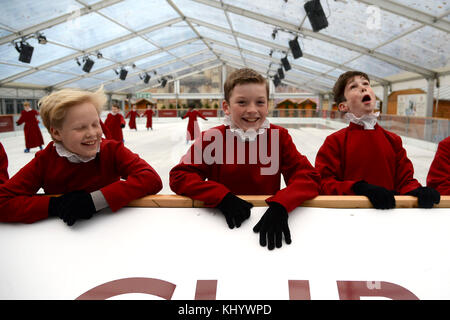 Choristers skating on the ice rink at Winchester Cathedral, Hampshire, UK Credit: Finnbarr Webster/Alamy Live News Stock Photo