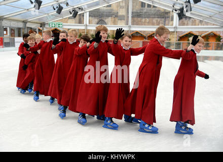 Choristers skating on the ice rink at Winchester Cathedral, Hampshire, UK Credit: Finnbarr Webster/Alamy Live News Stock Photo