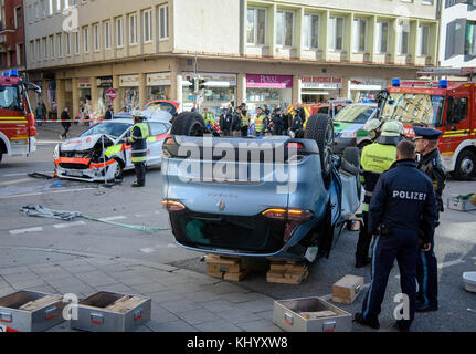 Munich, Germany. 22nd Nov, 2017. A crashed SUV lies on the street next to an emergency vehicle of the Johanniter accident relief after a crash with on Landwehstrasse street in the district of Ludwigsvorstadt-Isarvorstadt in Munich, Germany, 22 November 2017. The car of the Johanniter-Unfall-Hilfe (emergency relief) was on its way to an emergency. The reason for the accident is still unknown. Credit: Matthias Balk/dpa/Alamy Live News Stock Photo