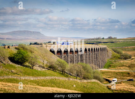 Northern Rail passenger train, crossing Ribblehead Viaduct on the Settle Carlisle line in the Yorkshire dales, England, UK