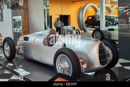 Europe, Germany, Saxony, Zwickau city, The August Horch Museum, old Bolide Auto Union Flèche d'Argent type C, 1934-1939 Le Mans,  Ferdinand Porsche, then employed by Auto Union, is the first to look into this new project. Porsche developed an imposing 'bolide' for the era: the chassis is entirely new, using aluminum beams in which the cooling water passes, the suspension uses A torsion bar, the gearbox is greased under pressure and the engine is a compressor V16. The presence of only three camshafts and 16 valves controlled by rods and tumblers from a common shaft testifies Stock Photo