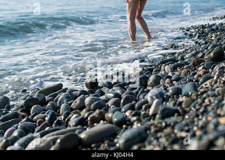 Stones on beach and sea water Stock Photo