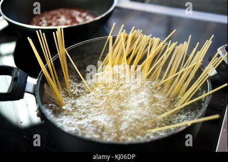 Cooking spaghetti in a pot with boiling water Stock Photo