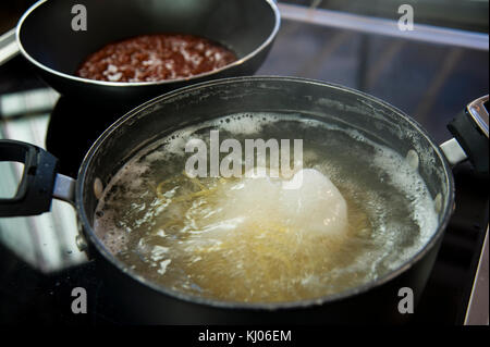 Cooking spaghetti in a pot with boiling water Stock Photo