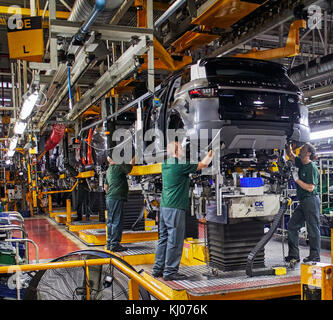 Workers on engine production line in car factory Stock Photo
