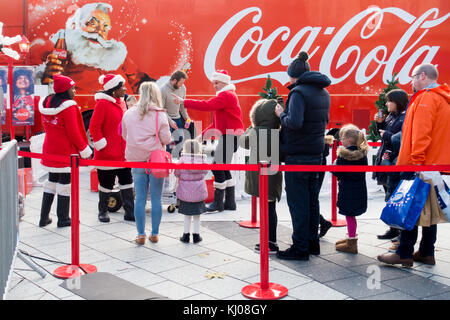 Cardiff, United Kingdom -  November 19, 2017: People are queueing in front of the Coca Cola Christmas truck in Cardiff to have their photos taken by t Stock Photo