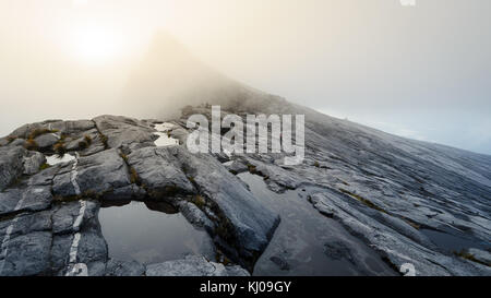 Barren rocky slopes and ponds of water on Mount Kinabalu, a volcano in Borneo, Malaysia. Stock Photo