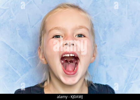 Cute cry girl with blond hair with open mouth Stock Photo