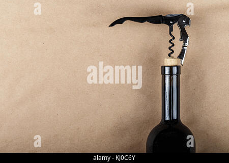 a bottle of wine is opened with a corkscrew, a corkscrew is screwed into a bottle stopper Stock Photo