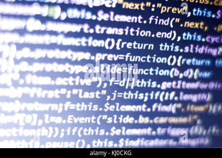 Glowing minificated javascript code. Abstract screen of modern web developer. Hacking computer network. Stock Photo