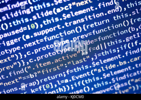 Glowing minificated javascript code. Abstract screen of modern web developer. Hacking computer network. Stock Photo