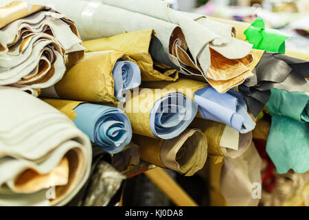 rolls of fabric wrapped in craft paper lying on each other. manufacture. close-up photo Stock Photo