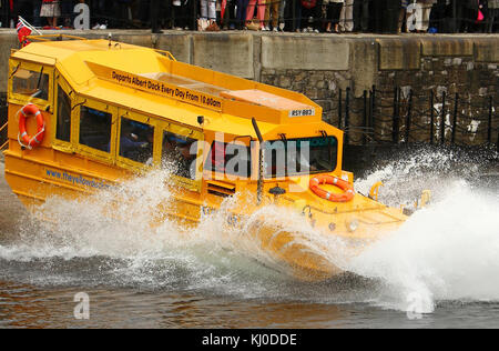 LIVERPOOL, ENGLAND - MAY 17: Queen Elizabeth II takes a ride on the Yellow Duck amphibious vehicle around Albert Dock during a visit to Merseyside Maritime Museum on May 17, 2012 in Liverpool, England. The Queen is visiting many parts of Britain as she celebrates her Diamond Jubilee culminating with a four-day public holiday on June 2-5, including a pageant of 1,000 boats on the River Thames.  People:  Queen Elizabeth II, Prince Philip Stock Photo