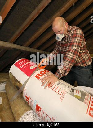 Richard Burr cutting up loft insulation for his DIY feature column ...