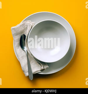 empty plate for soup on a yellow background Stock Photo