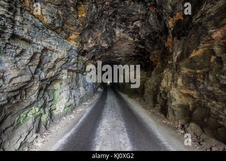 Long Dark Tunnel. Light at the end of the Nada Tunnel in rural Kentucky. The harrowing one way tunnel is open to two way traffic and located in USA. Stock Photo