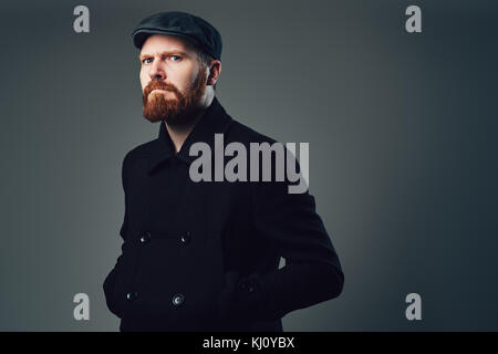 A man with redbeard over grey background. Stock Photo
