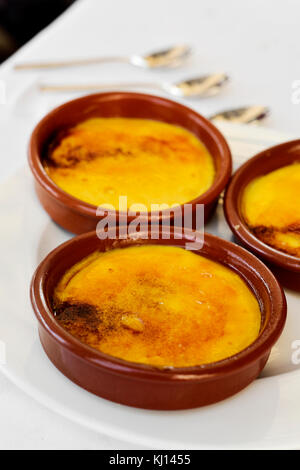 some earthenware bowls with crema catalana, typical creme brulee of Catalonia, Spain, on a table Stock Photo