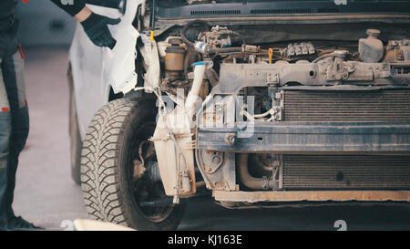 Damaged car preparing for professional diagnostics in auto service, close up Stock Photo