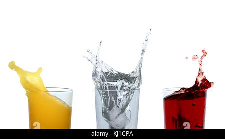 Three glasses with various motley splashing beverages. Isolated on white with clipping path Stock Photo