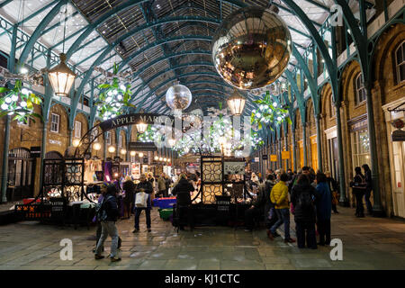 Christmas decorations adorn the Apple Market, East Colonade, Covent Garden, central London, England, UK Stock Photo