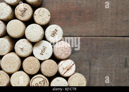 Background made from wine corks lying on wooden table Stock Photo