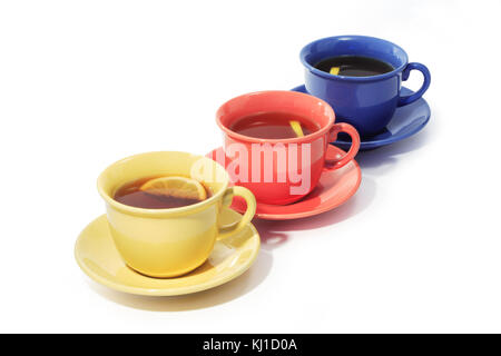 Three color cups of black tea with lemon isolated on white background with clipping path Stock Photo