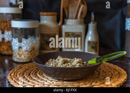 Oatmeal porridge with nuts and honey in a bowl Stock Photo