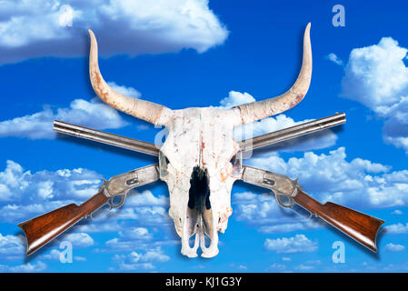 Antique cowboy lever action rifle and cow skull . Stock Photo