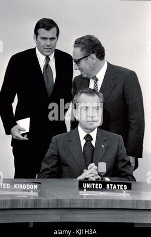 United States President Richard Nixon and Dr. Henry Kissinger, with Donald Rumsfeld at a 1974 NATO needing. Stock Photo