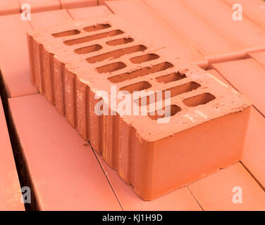 orange clay brick stack, pile. background. Stock Photo
