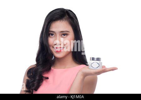 Pretty asian young woman holding moisturize jar Stock Photo
